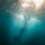 underwater photo of person diving