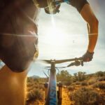 person riding bike near plants